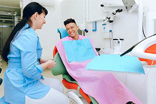 Smiling patient on treatment chair