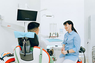 Patient on treatment chair talking to provider